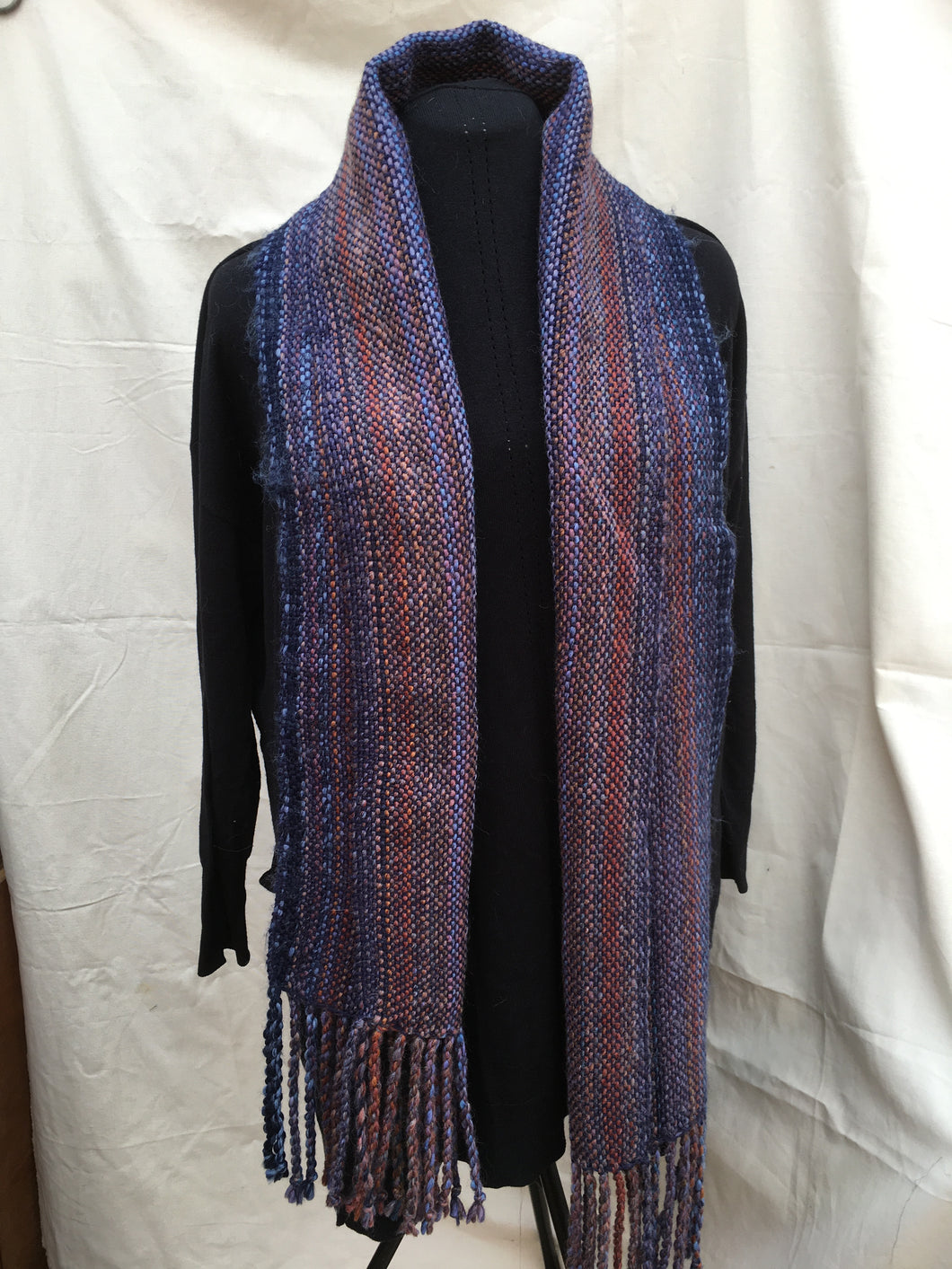 Scarf in a multi mix of rich darker colours.